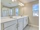Double vanity bathroom with white cabinets and a shower at 1413 August Gray Dr, Kissimmee, FL 34744