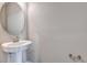 Small bathroom with pedestal sink and oval mirror at 1413 August Gray Dr, Kissimmee, FL 34744