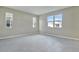 Spacious bedroom with three windows and tile flooring at 1413 August Gray Dr, Kissimmee, FL 34744