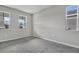 Bright bedroom with gray carpet and two large windows at 1413 August Gray Dr, Kissimmee, FL 34744