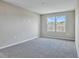 Spacious bedroom with grey carpet and two large windows at 1413 August Gray Dr, Kissimmee, FL 34744