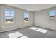 Well-lit bedroom featuring two large windows and grey carpet at 1413 August Gray Dr, Kissimmee, FL 34744