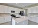 Modern kitchen featuring white cabinets, stainless steel appliances, and a large island at 1413 August Gray Dr, Kissimmee, FL 34744