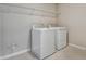 Convenient laundry room with washer, dryer, and overhead shelving at 1413 August Gray Dr, Kissimmee, FL 34744
