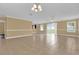 Large living room with tile floors, sliding glass doors, and neutral-colored walls at 1851 Rufus King Dr, Saint Cloud, FL 34769