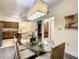 Bright dining room with glass table and chairs, adjacent to kitchen at 12544 Floridays Resort Dr # 202B, Orlando, FL 32821