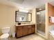 Bathroom with granite vanity, large mirror, shower, and bathtub at 12544 Floridays Resort Dr # 202B, Orlando, FL 32821