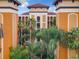 Exterior view of building with palm trees and Spanish-style architecture at 12544 Floridays Resort Dr # 202B, Orlando, FL 32821