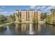 Building with lake view and water fountain at 12544 Floridays Resort Dr # 202B, Orlando, FL 32821