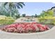 Florida Resort Orlando entrance, landscaped with red and white flowers at 12544 Floridays Resort Dr # 202B, Orlando, FL 32821