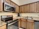 Well-equipped kitchen featuring granite countertops and stainless steel appliances at 12544 Floridays Resort Dr # 202B, Orlando, FL 32821