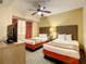 Bedroom with two double beds, nightstand, and TV at 12538 Floridays Resort Dr # C-211, Orlando, FL 32821