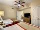 Bedroom with two double beds, dresser, and access to living area at 12538 Floridays Resort Dr # C-211, Orlando, FL 32821