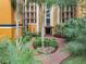Ground level courtyard with a walking path and tropical landscaping at 12538 Floridays Resort Dr # C-211, Orlando, FL 32821