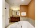 Bathroom with corner jacuzzi tub and double vanity at 12538 Floridays Resort Dr # C-211, Orlando, FL 32821