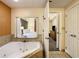 Bathroom with jacuzzi tub and view of bedroom at 12538 Floridays Resort Dr # C-211, Orlando, FL 32821