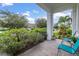 Peaceful front porch with seating and lovely landscaping at 5012 E Fountainwood Dr, St Cloud, FL 34772