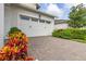 Two-car garage with white doors and brick driveway at 5012 E Fountainwood Dr, St Cloud, FL 34772