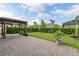 Spacious backyard with paver patio, pergola, and green lawn at 5012 E Fountainwood Dr, St Cloud, FL 34772