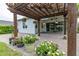 Relaxing backyard patio with pergola, pavers, and lush landscaping at 5012 E Fountainwood Dr, St Cloud, FL 34772