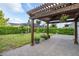 Wooden pergola with hanging plants and string lights at 5012 E Fountainwood Dr, St Cloud, FL 34772