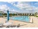 Resort-style swimming pool with lounge chairs and patio tables at 5012 E Fountainwood Dr, St Cloud, FL 34772