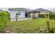 Large backyard with grassy area and paver patio at 5012 E Fountainwood Dr, St Cloud, FL 34772