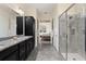 Clean bathroom with double vanity, granite countertop, and glass shower at 5012 E Fountainwood Dr, St Cloud, FL 34772