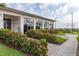 Community clubhouse with landscaped walkway and lush greenery at 5012 E Fountainwood Dr, St Cloud, FL 34772