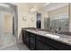Modern bathroom with double vanity, granite countertops, and a view into the bedroom at 5012 E Fountainwood Dr, St Cloud, FL 34772