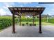 Covered patio with pergola, string lights, and potted plants at 5012 E Fountainwood Dr, St Cloud, FL 34772