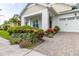 Inviting front yard with colorful landscaping and brick pavers at 5012 E Fountainwood Dr, St Cloud, FL 34772