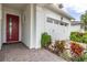 Front entry and attached garage with paver driveway and landscaping at 5012 E Fountainwood Dr, Saint Cloud, FL 34772