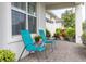 Covered porch with teal chairs, offering a peaceful view at 5012 E Fountainwood Dr, St Cloud, FL 34772