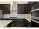 Modern kitchen with granite countertops, stainless steel appliances, and dark cabinetry at 5012 E Fountainwood Dr, St Cloud, FL 34772
