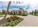 Gated entrance to community with landscaping and pavers at 5012 E Fountainwood Dr, St Cloud, FL 34772