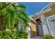 Tan house with white trim, palm trees, and a paved walkway at 220 Lewis Dr, Davenport, FL 33837