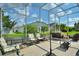Spacious screened patio with seating and a fountain at 220 Lewis Dr, Davenport, FL 33837