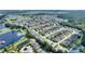 Aerial view showcasing the property's setting within a residential community near a lake at 220 Lewis Dr, Davenport, FL 33837