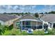 House with screened patio, lush landscaping, and neighborhood view at 220 Lewis Dr, Davenport, FL 33837