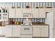 White kitchen cabinets and granite countertops at 220 Lewis Dr, Davenport, FL 33837