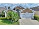 Two-story house with a white garage door at 220 Lewis Dr, Davenport, FL 33837