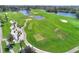 Aerial view of a lush golf course with water features and palm trees at 220 Lewis Dr, Davenport, FL 33837