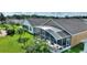 House with screened patio, lush landscaping, and neighborhood view at 220 Lewis Dr, Davenport, FL 33837