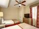 Bedroom with two twin beds, TV and ceiling fan at 12544 Floridays Resort Dr # 109-B, Orlando, FL 32821