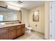 Bathroom with granite vanity, tiled floor, and a large mirror at 12544 Floridays Resort Dr # 109-B, Orlando, FL 32821