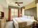 King-size bed, nightstands, and ceiling fan in the main bedroom at 12544 Floridays Resort Dr # 109-B, Orlando, FL 32821