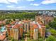 Aerial view of a large apartment building with a pool and surrounding landscape at 12544 Floridays Resort Dr # 109-B, Orlando, FL 32821