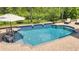 Inviting swimming pool with brick pavers and a relaxing patio umbrella at 2891 Swoop Cir, Kissimmee, FL 34741