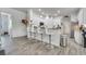 Kitchen with white cabinets, breakfast bar, and wood-look floors at 2891 Swoop Cir, Kissimmee, FL 34741